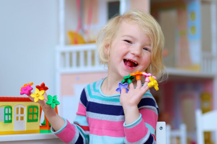 Preschool girl with toys on her fingers