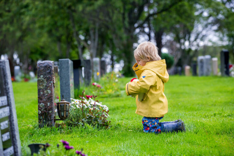 Sad child at cemetary