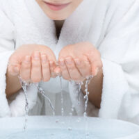 Teen Girl Washing Her Face in Her Bathrobe