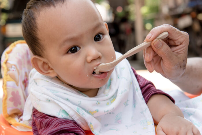 baby eating food from a spoon